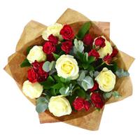 Delicate bouquet of white roses and red bush roses