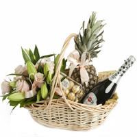 Basket with lilies, roses and sweets