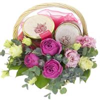 Basket with bush rose, eustoma and jam