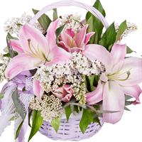 Composition in a basket with lilies and lilacs