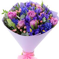 A bouquet with delicate peony tulips and bright blue irises