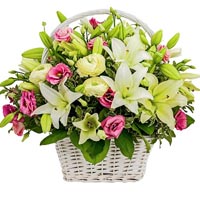 Bouquet of white lily and pink eustoma in basket