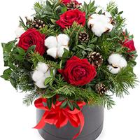 Christmas composition of roses and cotton in a box