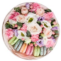 Box with delicate flowers and macaroons