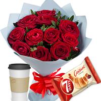 Bouquet of red roses with coffee and croissant