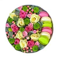 Macaroons and flowers in a box