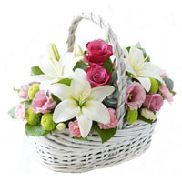 Bouquet of lilies, bush roses, eustoma, chrysanthemums in basket